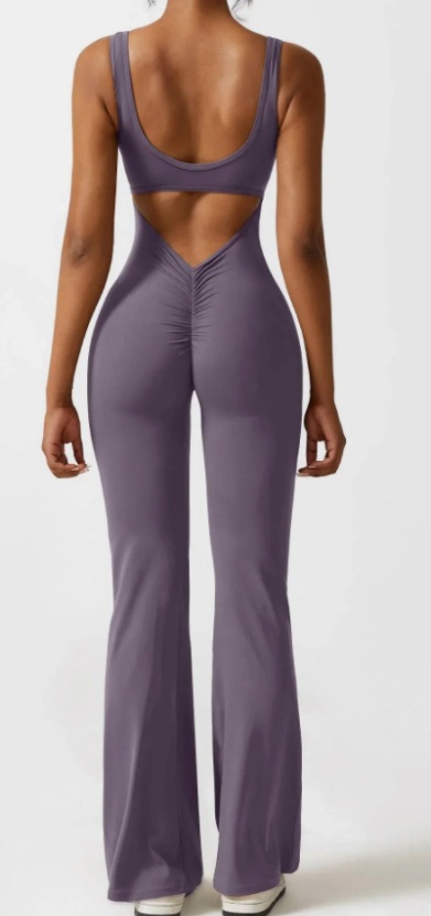 Woman wearing seamless hollow yoga bodysuit with cut-out details and flexible fabric in casual activewear pose